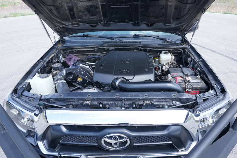 ProCharger Toyota Tacoma 4.0L installation reference. Appearance varies with selected finish and installation; pictured vehicle and unrelated accessories are not included.