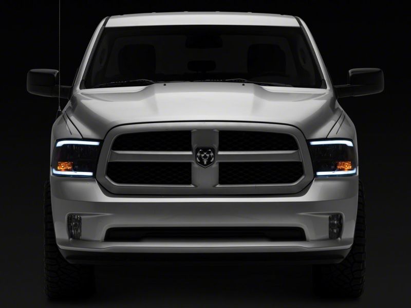 Raxiom 09-18 Dodge RAM 1500/2500/3500 Axial Headlights w/ SEQL LED Bar- Black Housing (Clear Lens)