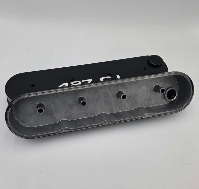 Underside of tall GM LS 427 Stroker aluminum valve covers showing center-bolt mounting bosses